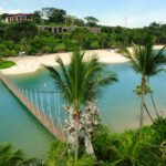 Palewan Beach, Sentosa, Singapore. The beach is a popular attraction for local people and tourists in Singapore. It is situated on the southern tip of Sentosa Island. The rope bridge connects the beach to viewing platforms overlooking the Singapore Strait.